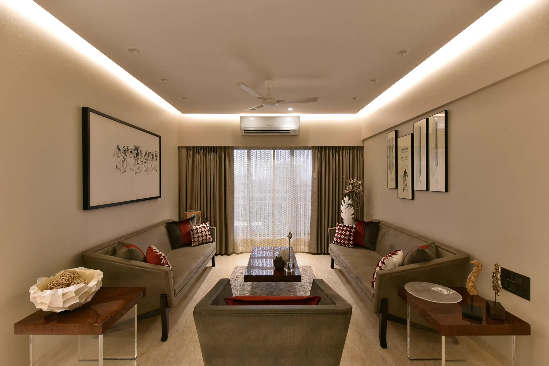 Living room with false ceiling cove LED strip and slim recessed can lights at warm 2700K colour temperature.